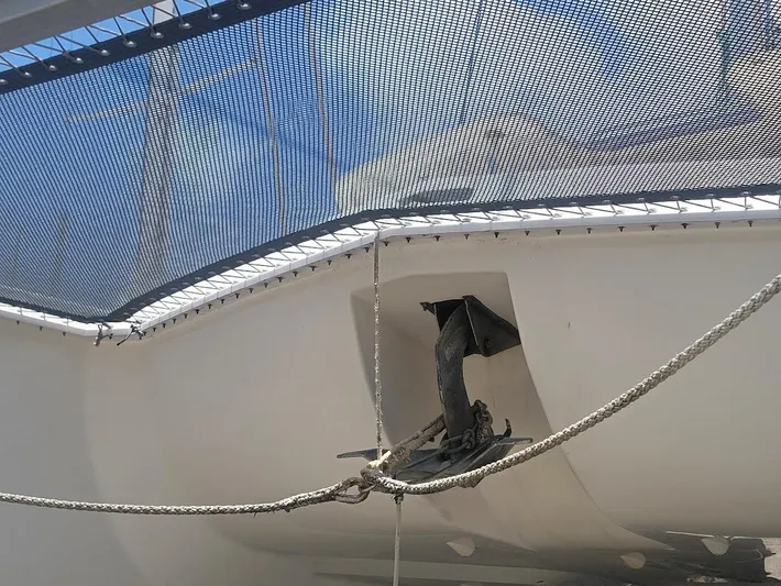 Kitten Caboodle Yacht Photos Pics Leopard 44 catamaran anchor and netting, 2015 model, under clear blue sky.