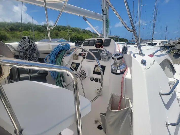 Kitten Caboodle Yacht Photos Pics 2015 Leopard 44 yacht cockpit with steering wheel and navigation controls.