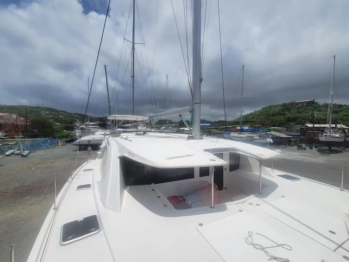 Kitten Caboodle Yacht Photos Pics 2015 Leopard 44 catamaran docked, showcasing sleek design and spacious deck under cloudy skies.