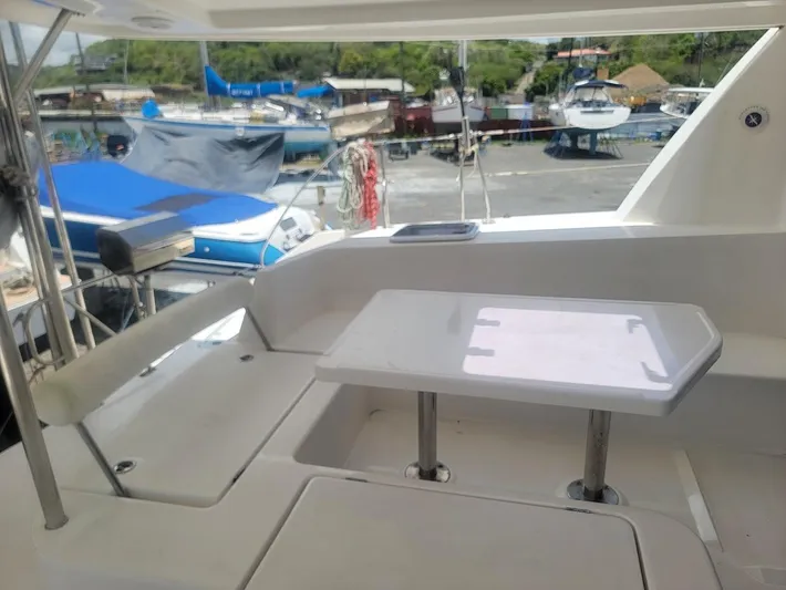 Kitten Caboodle Yacht Photos Pics Leopard 44 yacht deck with seating and table, docked at marina, 2015 model.