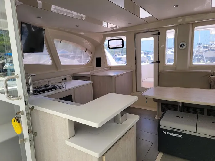 Kitten Caboodle Yacht Photos Pics Interior of 2015 Leopard 44 catamaran with modern kitchen and seating area.