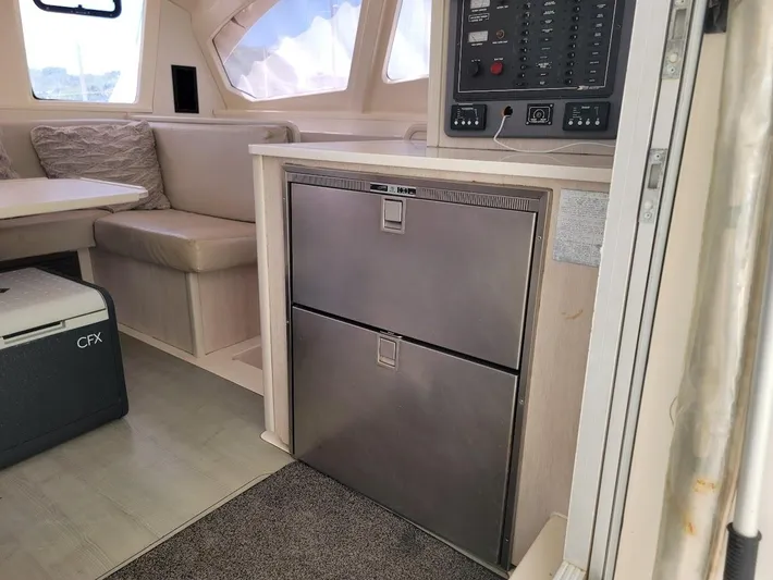 Kitten Caboodle Yacht Photos Pics Interior of a 2015 Leopard 44 yacht with seating and control panel.