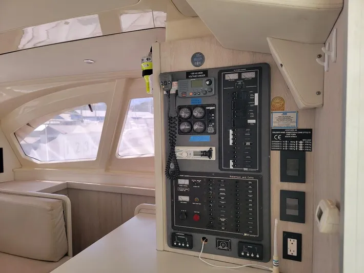 Kitten Caboodle Yacht Photos Pics Control panel inside a 2015 Leopard 44 catamaran, featuring navigation and electrical systems.