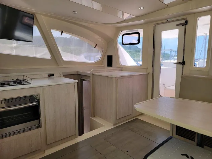 Kitten Caboodle Yacht Photos Pics Interior of 2015 Leopard 44 catamaran with modern kitchen and dining area.