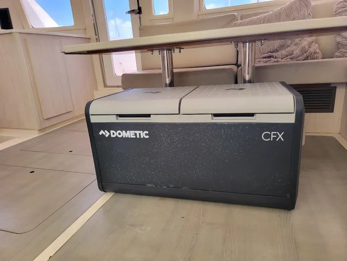 Kitten Caboodle Yacht Photos Pics Dometic CFX cooler inside a 2015 Leopard 44 catamaran, under a table.
