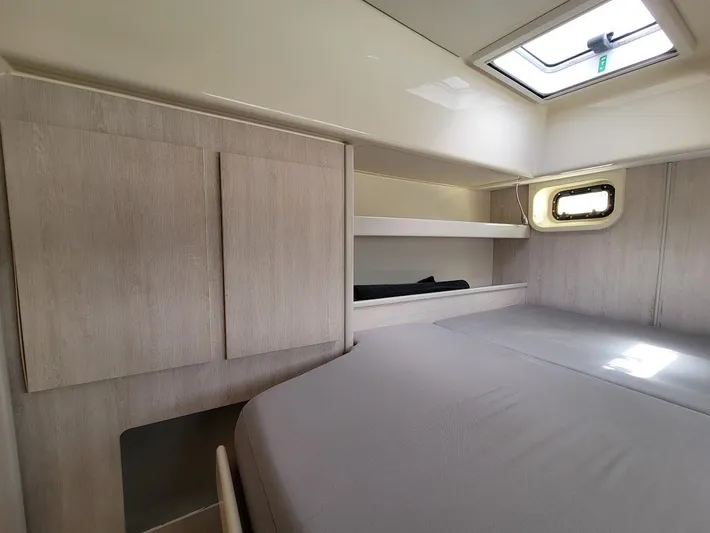 Kitten Caboodle Yacht Photos Pics Cozy cabin interior of 2015 Leopard 44 yacht with bed, storage, and window.