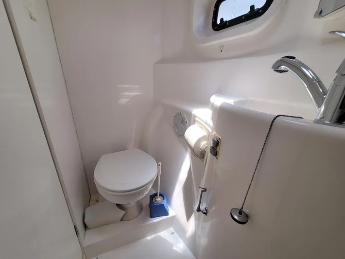 Kitten Caboodle Yacht Photos Pics Compact bathroom in a 2015 Leopard 44 yacht, featuring a toilet and sink.