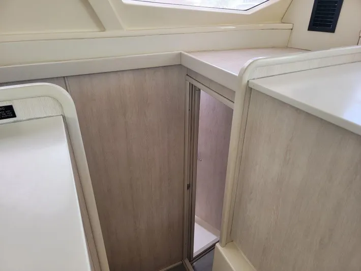 Kitten Caboodle Yacht Photos Pics Interior view of a 2015 Leopard 44 yacht, featuring light wood paneling and modern design.