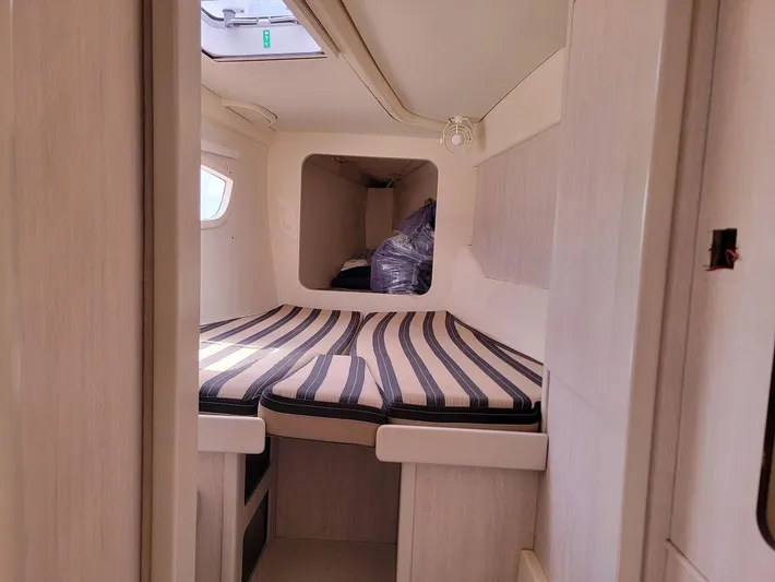 Kitten Caboodle Yacht Photos Pics Cozy cabin interior of 2015 Leopard 44 yacht with striped bedding.