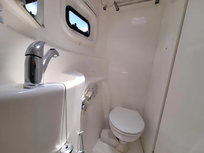 Kitten Caboodle Yacht Photos Pics Compact bathroom in a 2015 Leopard 44 yacht with modern fixtures and porthole window.