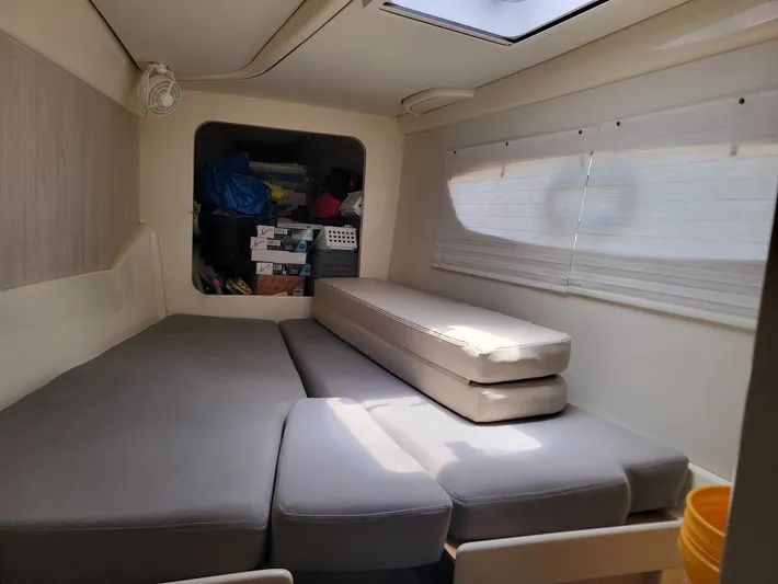 Kitten Caboodle Yacht Photos Pics Interior of a 2015 Leopard 44 catamaran with gray seating and storage area.