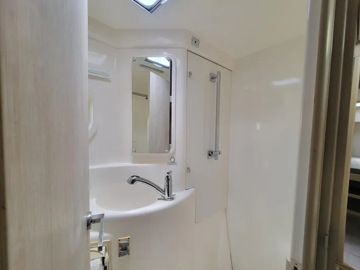 Kitten Caboodle Yacht Photos Pics Compact bathroom in 2015 Leopard 44 yacht, featuring a sleek sink and mirror.