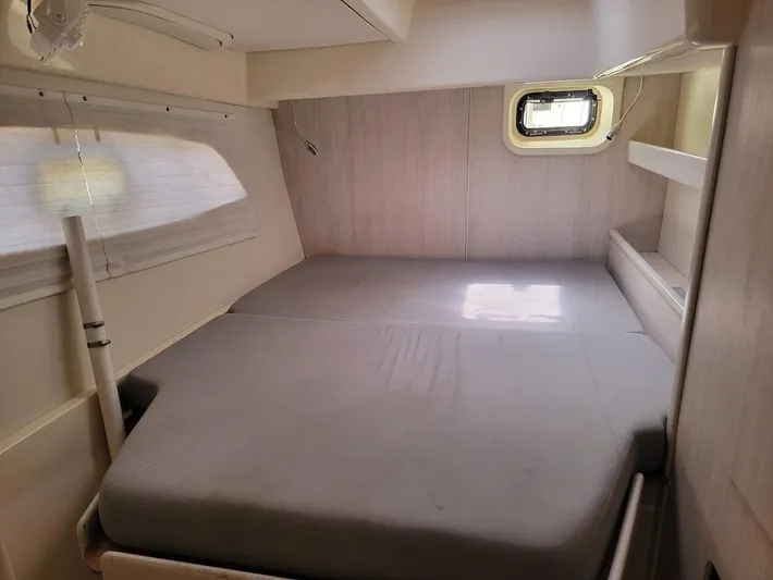 Kitten Caboodle Yacht Photos Pics Cozy cabin interior of 2015 Leopard 44 yacht with bed and window.