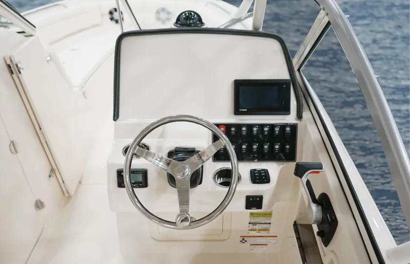  Yacht Photos Pics Helm of 2026 Grady-White GW 235 Freedom boat with steering wheel and control panel.