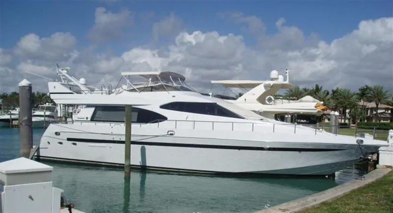  Yacht Photos Pics 1993 Tecnomarine yacht docked in a marina under a partly cloudy sky.