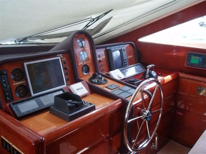  Yacht Photos Pics 1993 Tecnomarine yacht helm with navigation instruments and wooden dashboard.