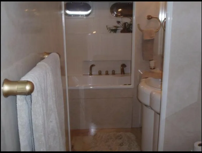  Yacht Photos Pics Luxurious 1993 Tecnomarine yacht bathroom with elegant fixtures and plush towels.