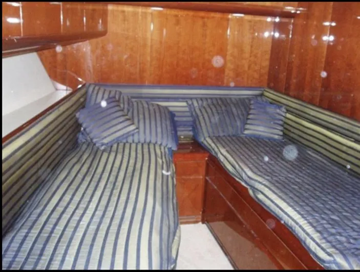  Yacht Photos Pics Twin beds with striped bedding in 1993 Tecnomarine yacht cabin.
