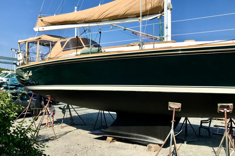  Yacht Photos Pics 2002 Sabre 402 sailboat on stands, green hull, tan covers, outdoor setting.
