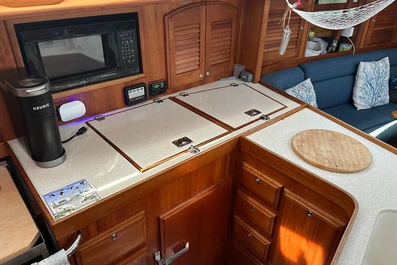  Yacht Photos Pics Interior of 2002 Sabre 402 yacht kitchen with wooden cabinetry and modern appliances.
