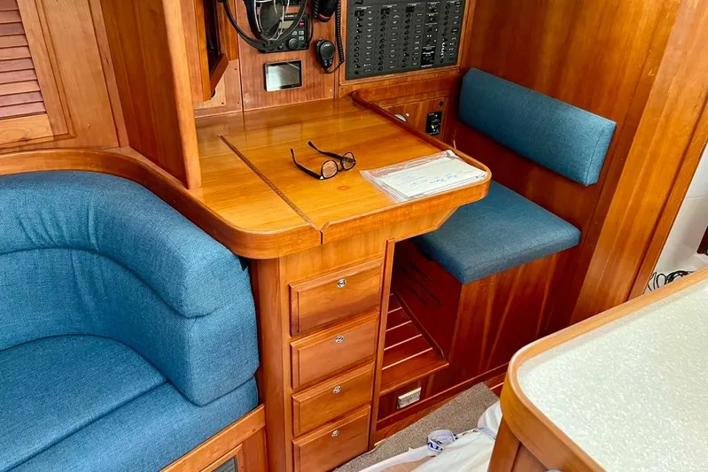  Yacht Photos Pics Interior of 2002 Sabre 402 yacht with wooden cabinetry and blue seating.