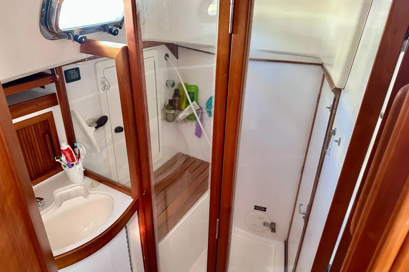  Yacht Photos Pics 2002 Sabre 402 yacht bathroom with wooden accents and shower area.