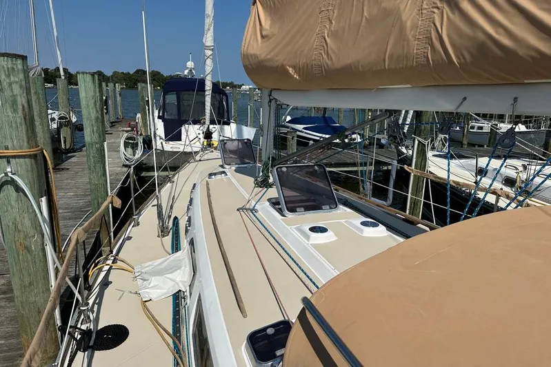  Yacht Photos Pics 2002 Sabre 402 sailboat docked at marina, featuring tan deck and rigging.