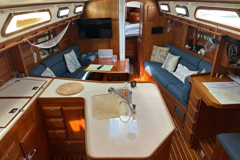  Yacht Photos Pics Interior of 2002 Sabre 402 sailboat with cozy seating and wooden cabinetry.