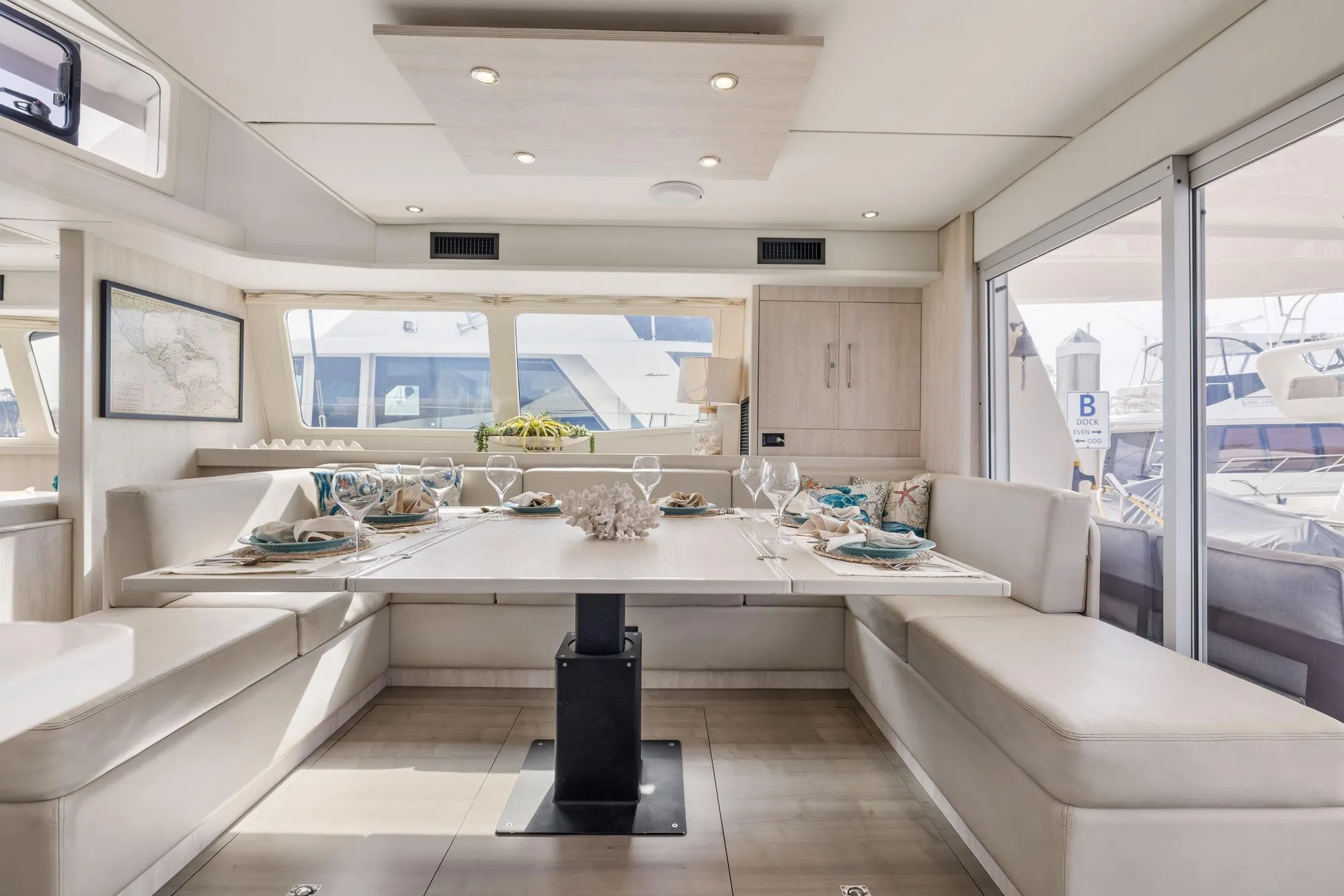 Luxurious dining area on a 2015 Leopard 58 yacht, featuring elegant table settings and panoramic windows.