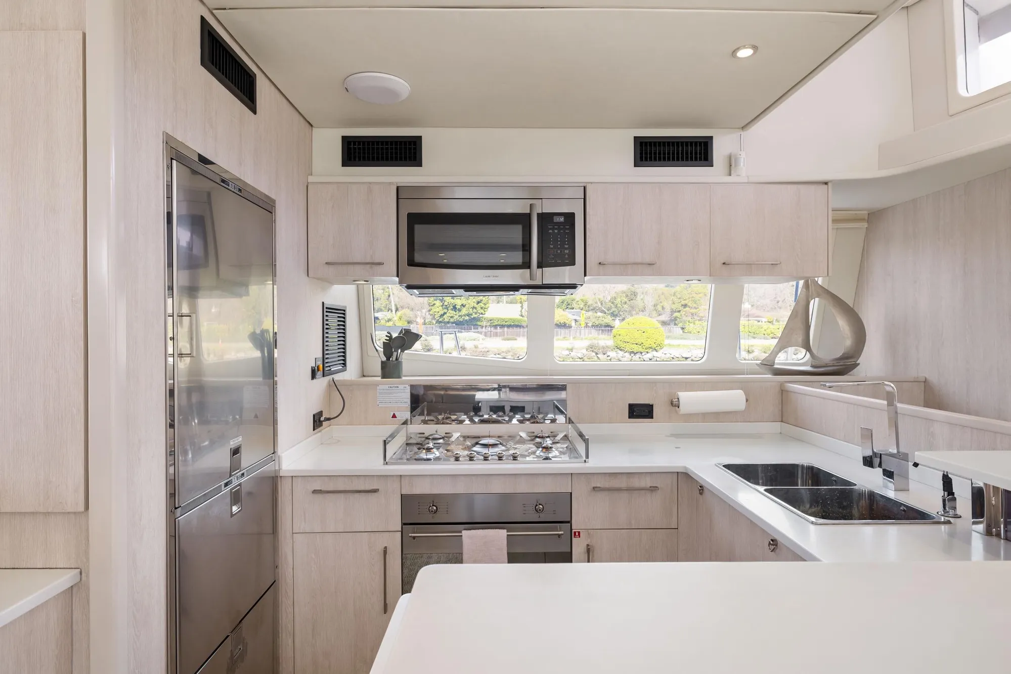 Modern kitchen interior on a 2015 Leopard 58 yacht, featuring sleek appliances and ample counter space.