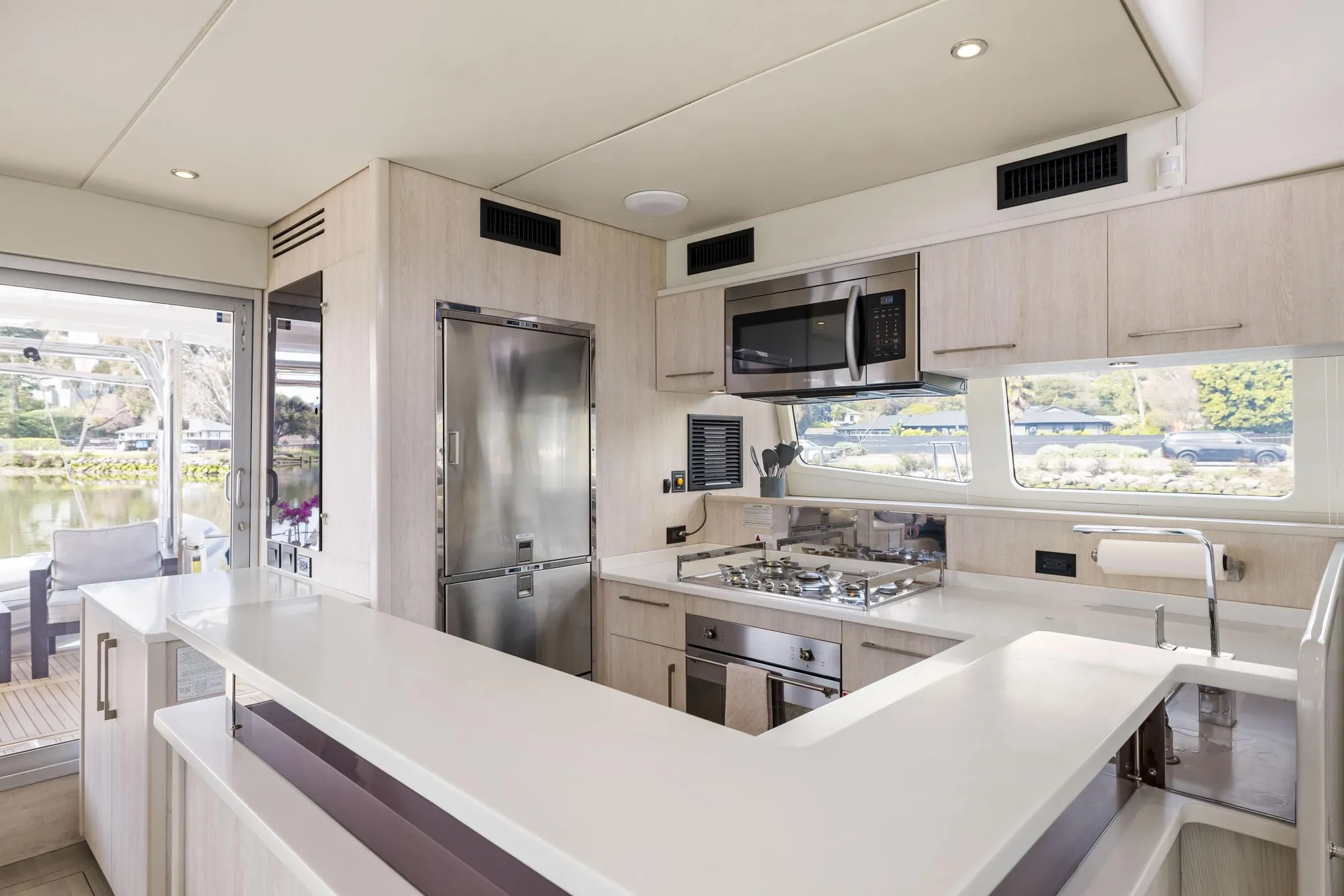 Luxurious kitchen interior of 2015 Leopard 58 yacht with modern appliances and sleek design.