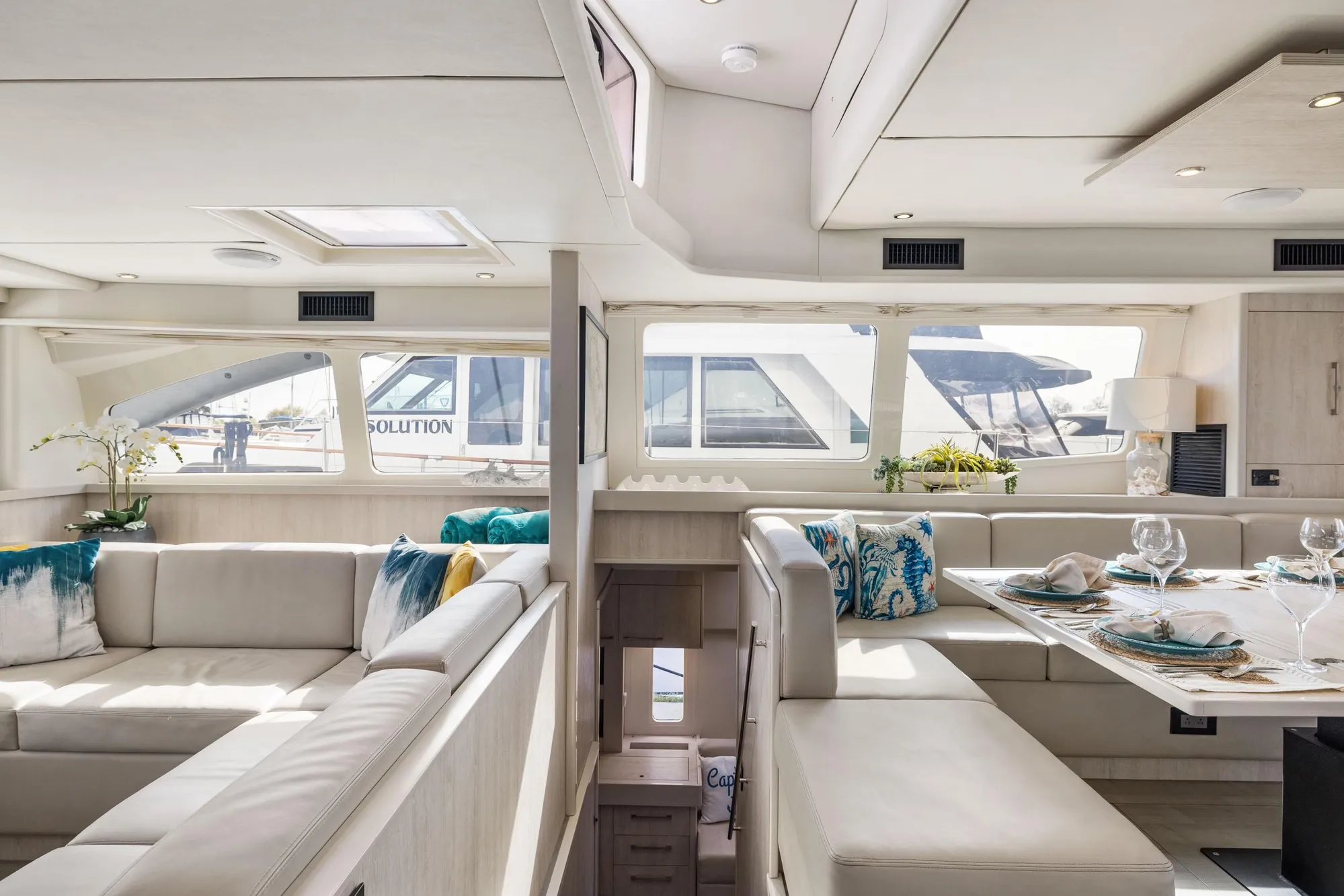 Luxurious interior of a 2015 Leopard 58 yacht with elegant seating and dining area.