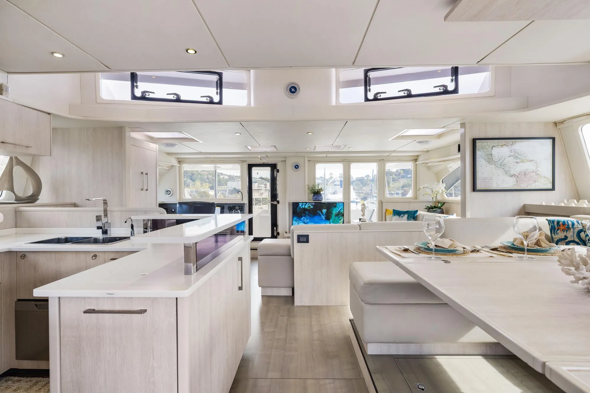 Luxurious interior of 2015 Leopard 58 yacht with modern kitchen and dining area.