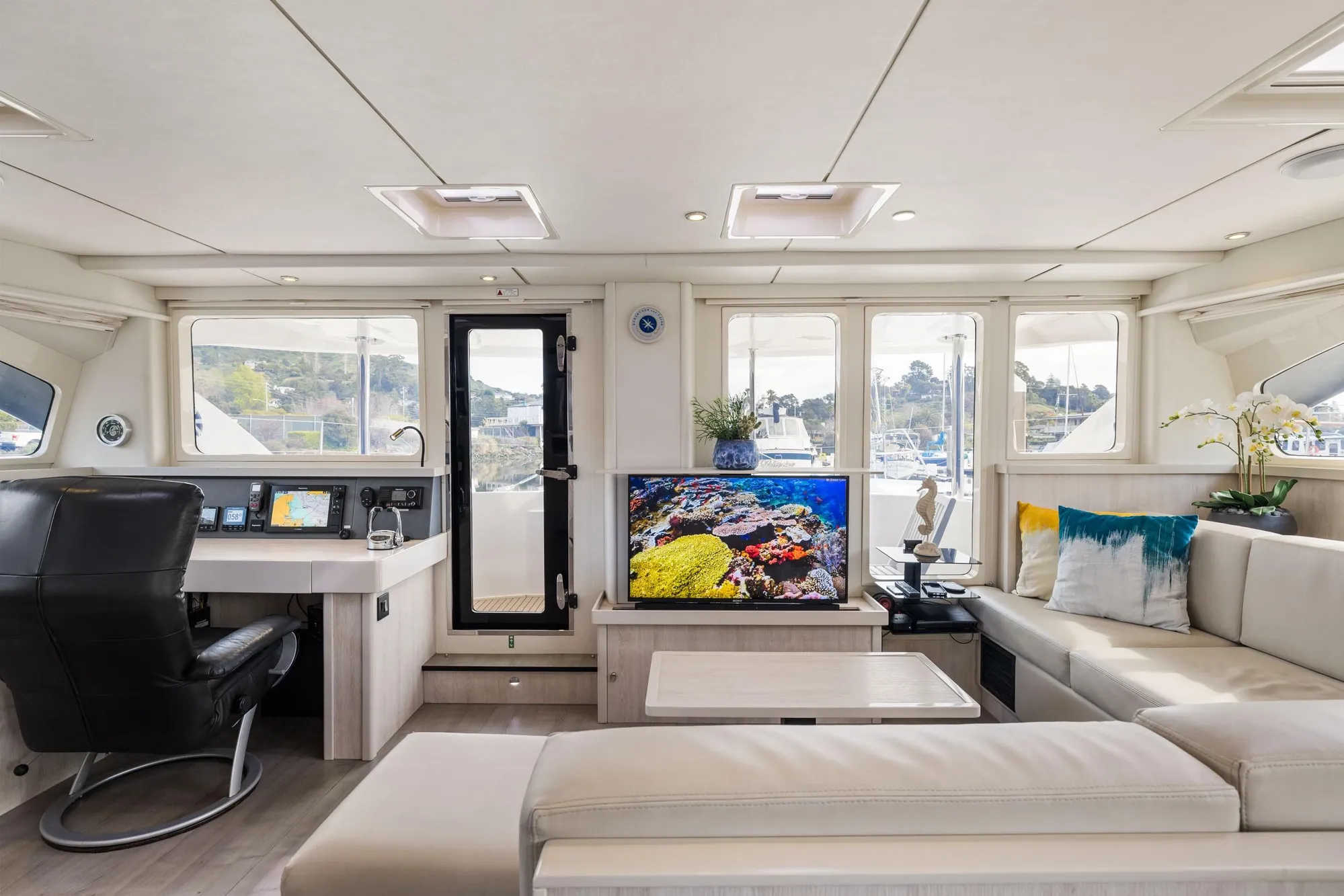 Luxurious interior of 2015 Leopard 58 yacht with modern decor and panoramic windows.