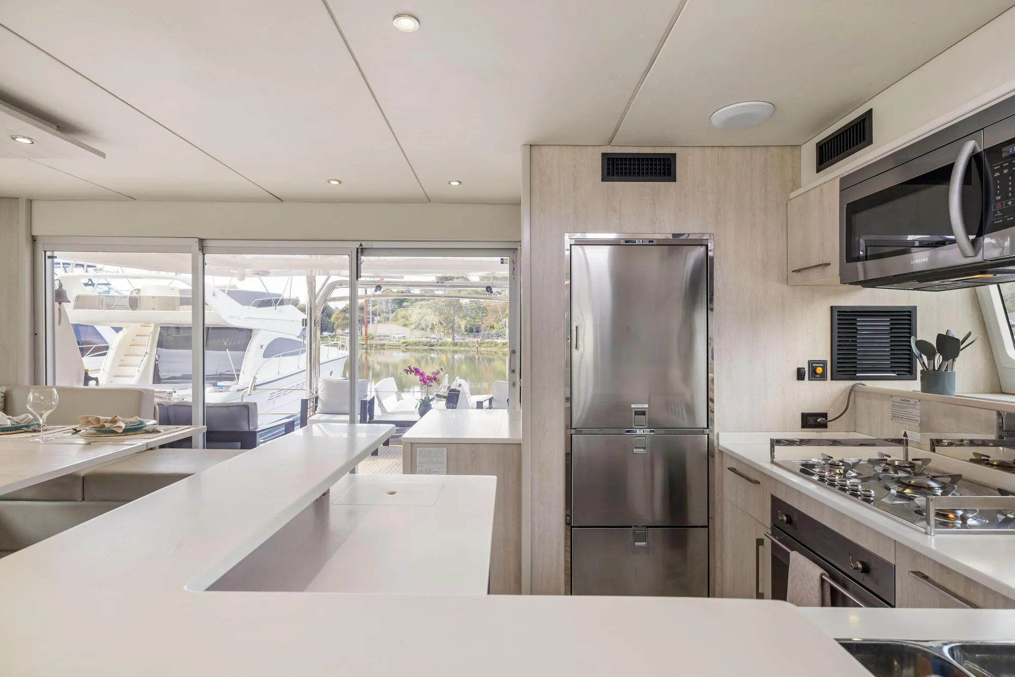 Luxurious kitchen interior of 2015 Leopard 58 yacht with modern appliances and sleek design.