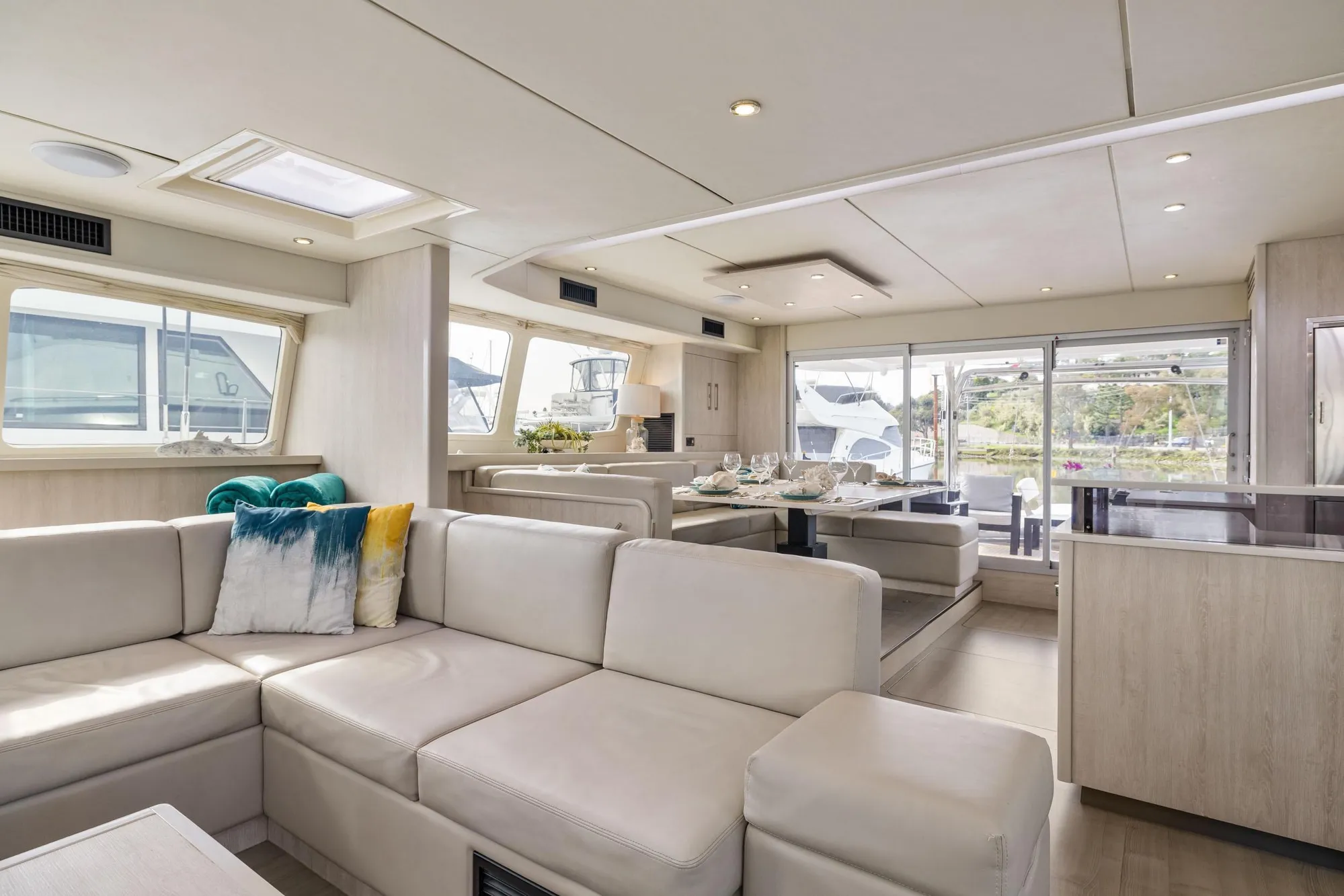 Luxurious interior of 2015 Leopard 58 yacht with modern seating and dining area.