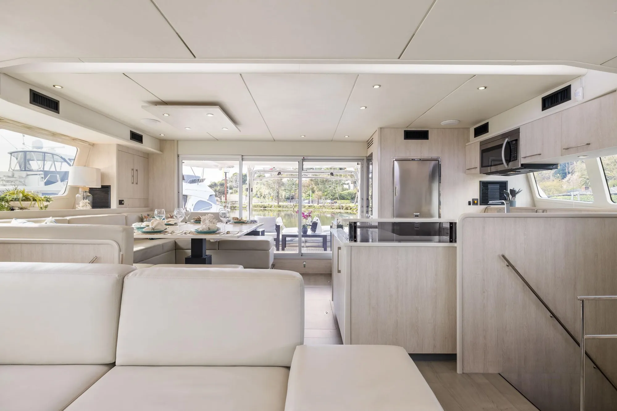 Luxurious interior of a 2015 Leopard 58 yacht with modern kitchen and dining area.
