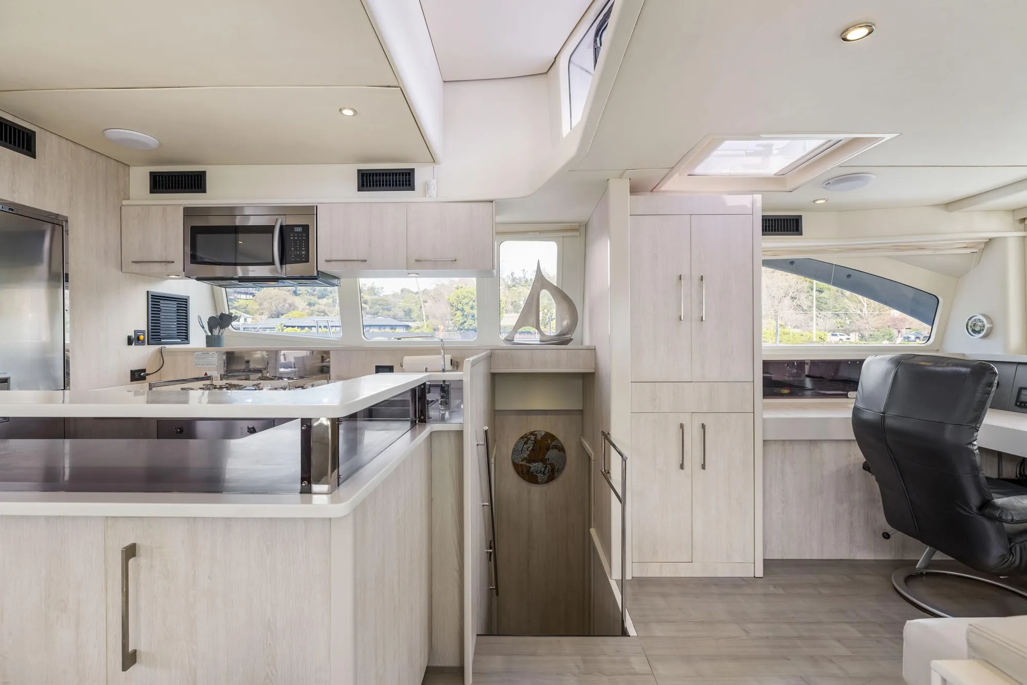 Luxurious interior of 2015 Leopard 58 yacht featuring modern kitchen and seating area.