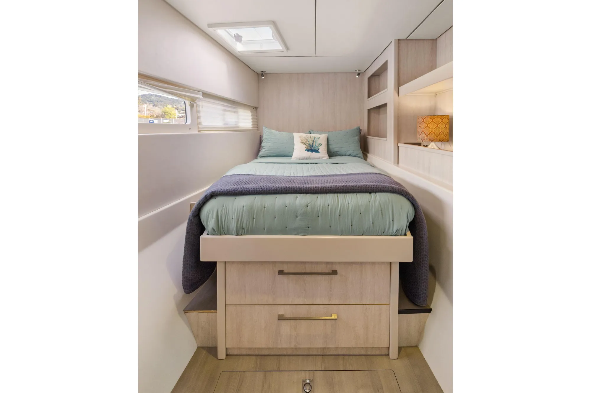 Cozy bedroom in 2015 Leopard 58 yacht with modern decor and storage drawers.