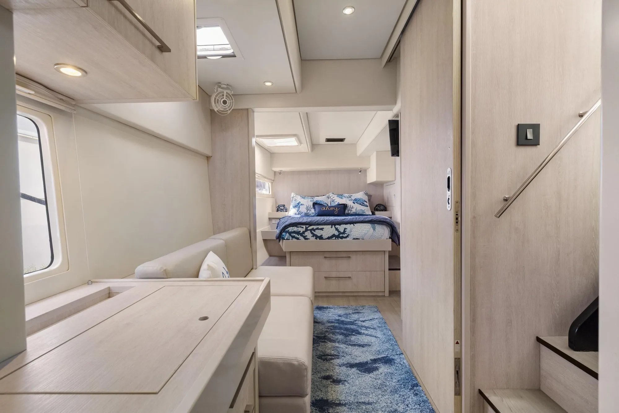 Luxurious interior of 2015 Leopard 58 yacht with modern bedroom and seating area.