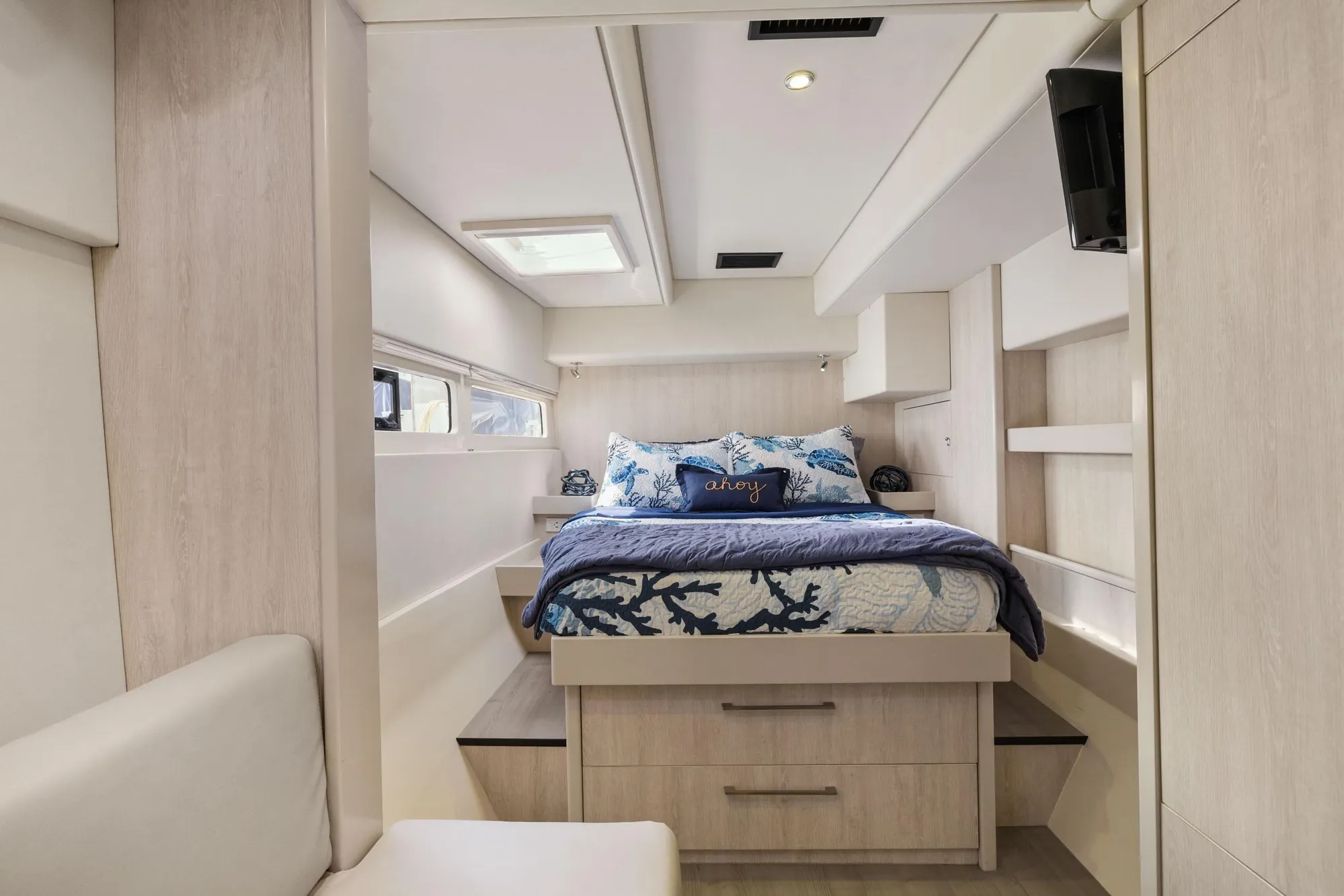 Luxurious bedroom interior of 2015 Leopard 58 yacht with modern decor and natural light.