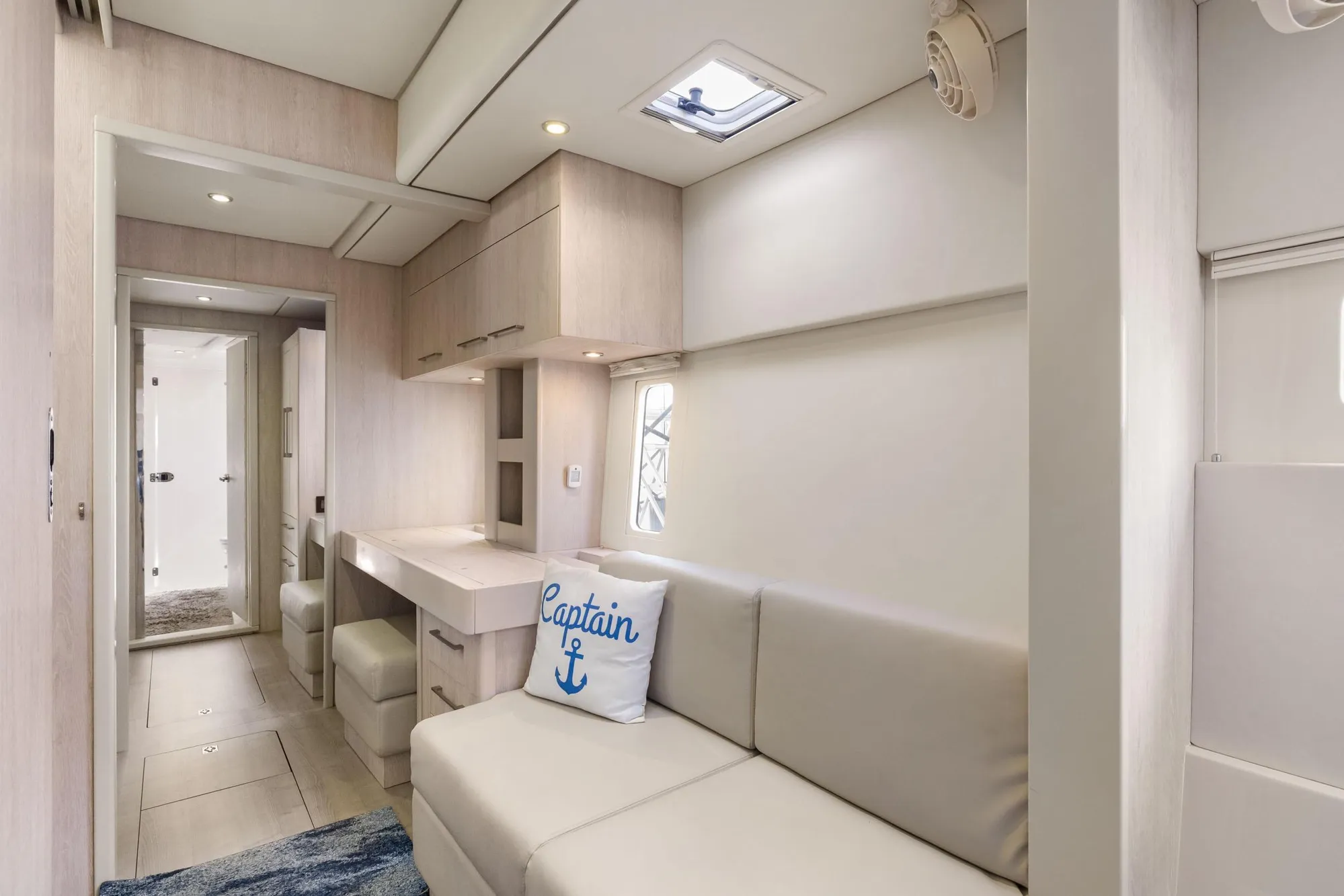 Interior of 2015 Leopard 58 yacht with modern decor and "Captain" pillow.
