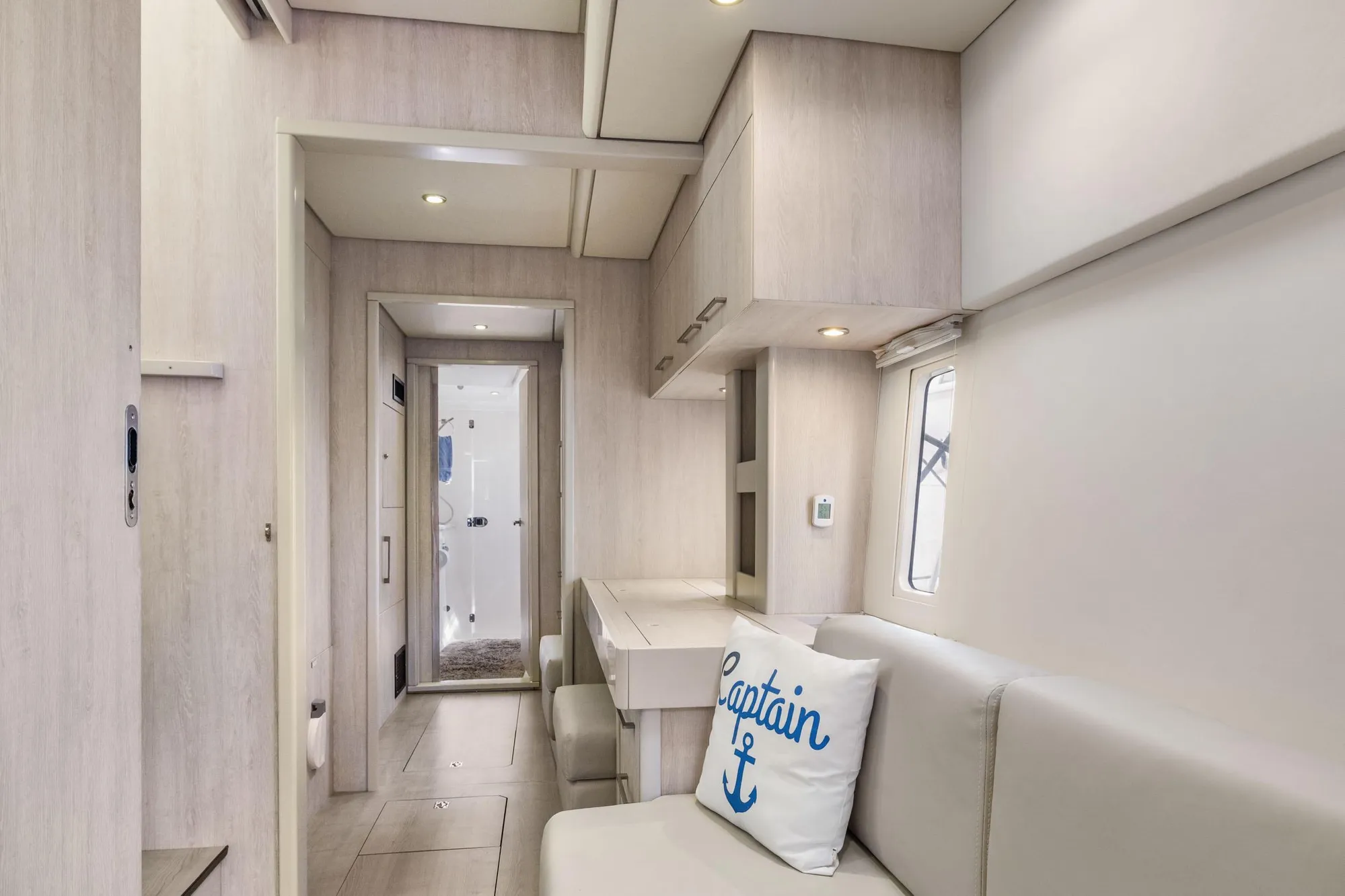 Luxurious interior of 2015 Leopard 58 yacht with modern seating and nautical decor.