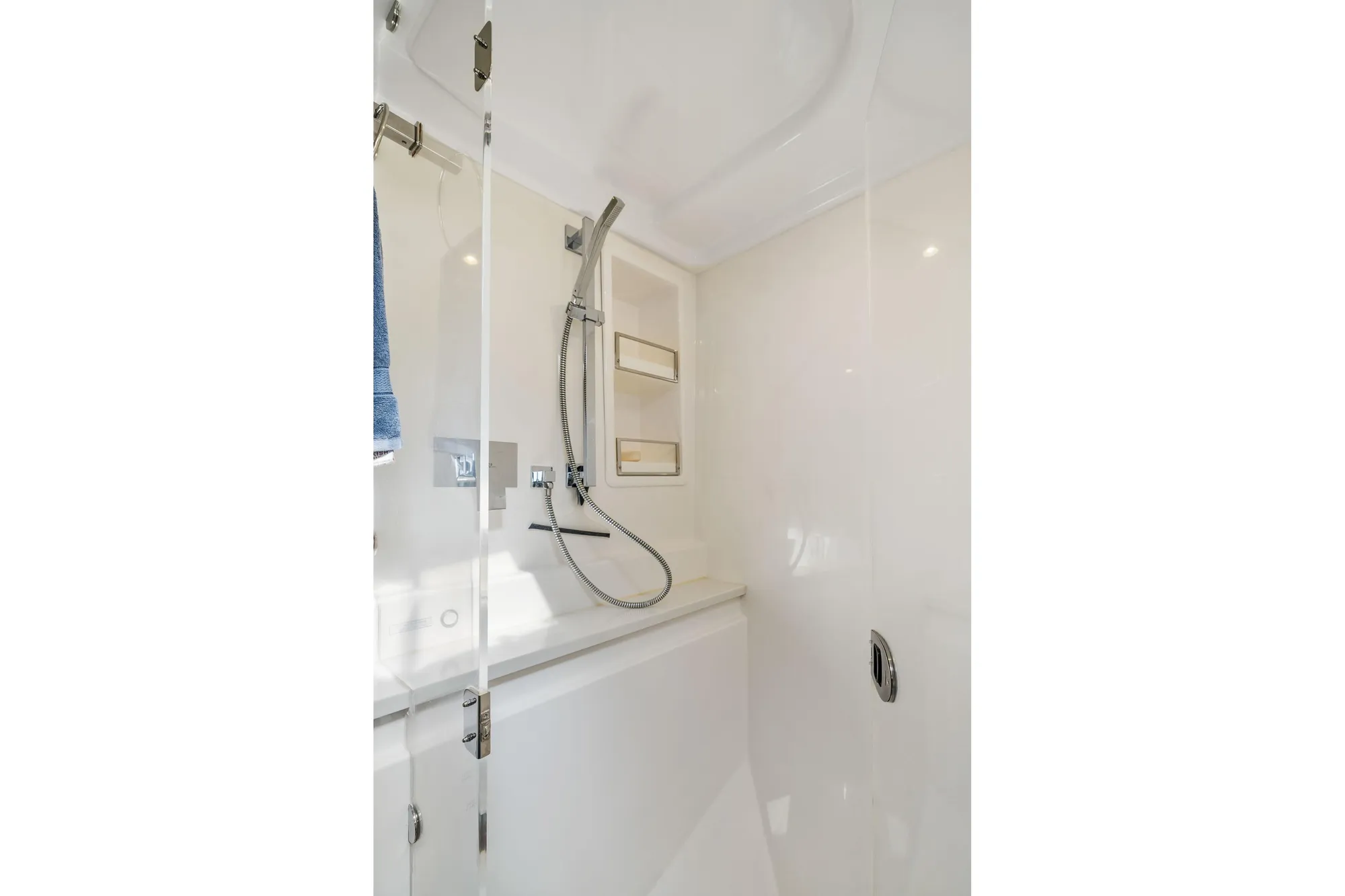 Modern shower area in 2015 Leopard 58 yacht with sleek fixtures and glass door.