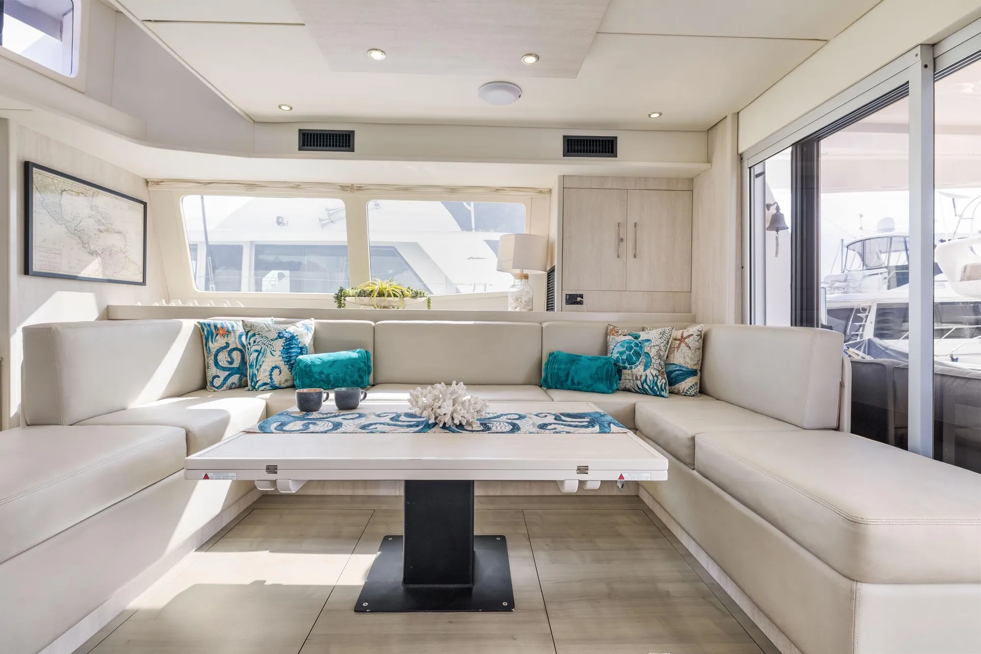 Luxurious interior of 2015 Leopard 58 yacht with elegant seating and decorative pillows.