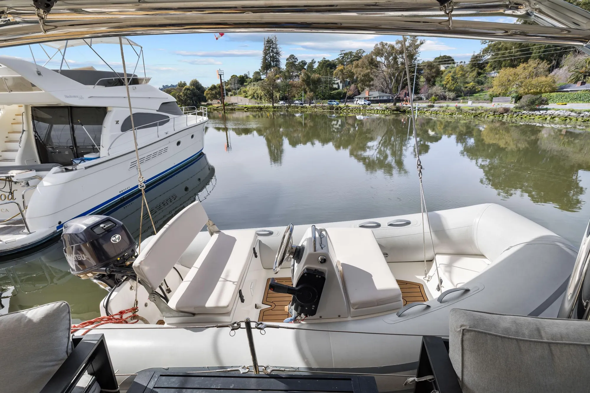 Luxury Leopard 58 yacht docked by serene waters, 2015 model, with inflatable boat.