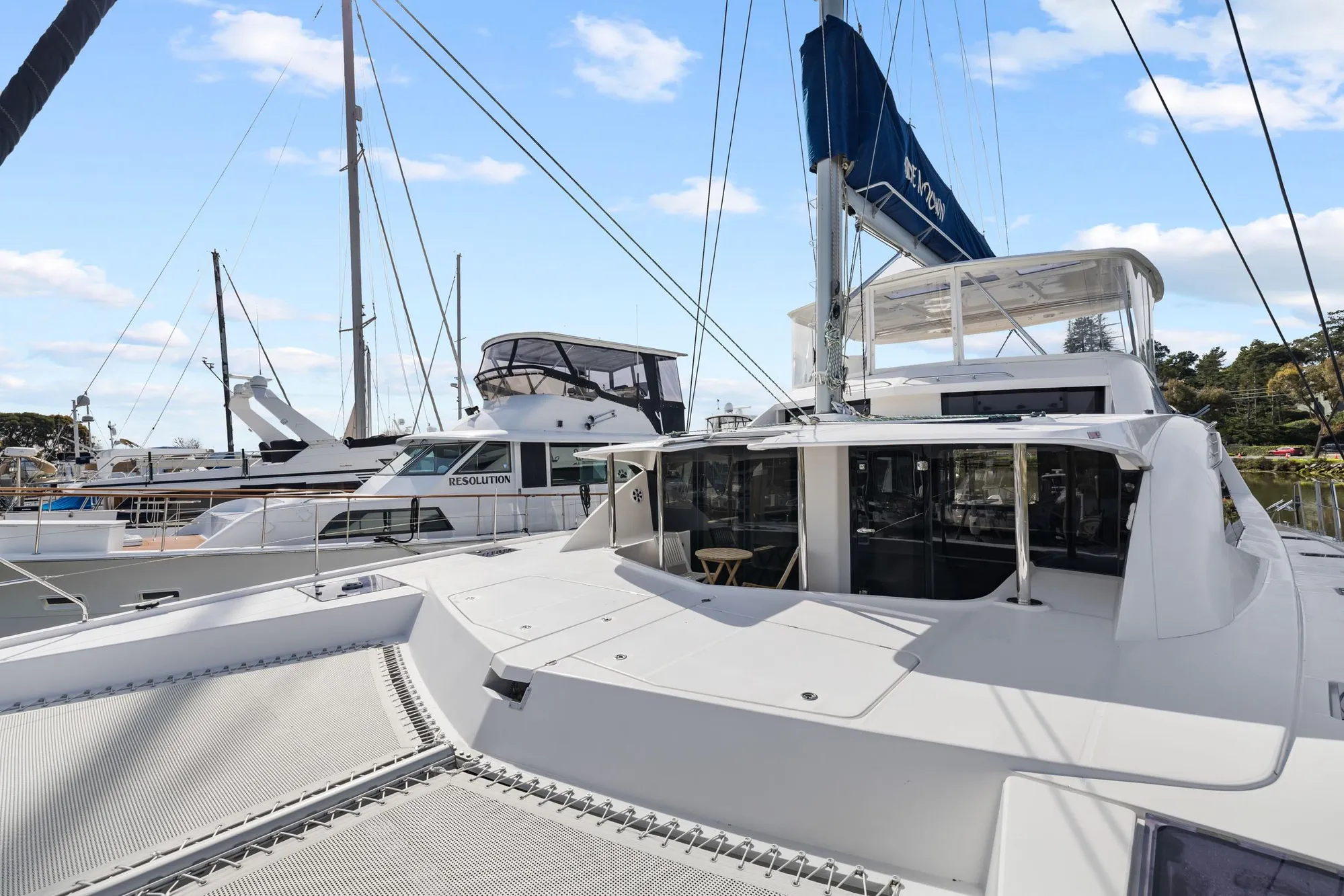 2015 Leopard 58 catamaran docked at marina, featuring spacious deck and modern design.