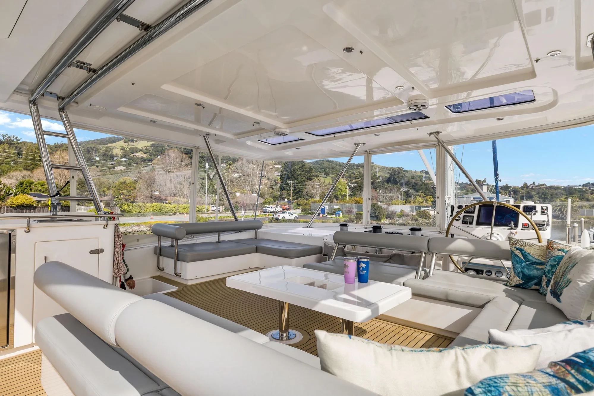 Luxurious 2015 Leopard 58 yacht interior with spacious seating and scenic views.
