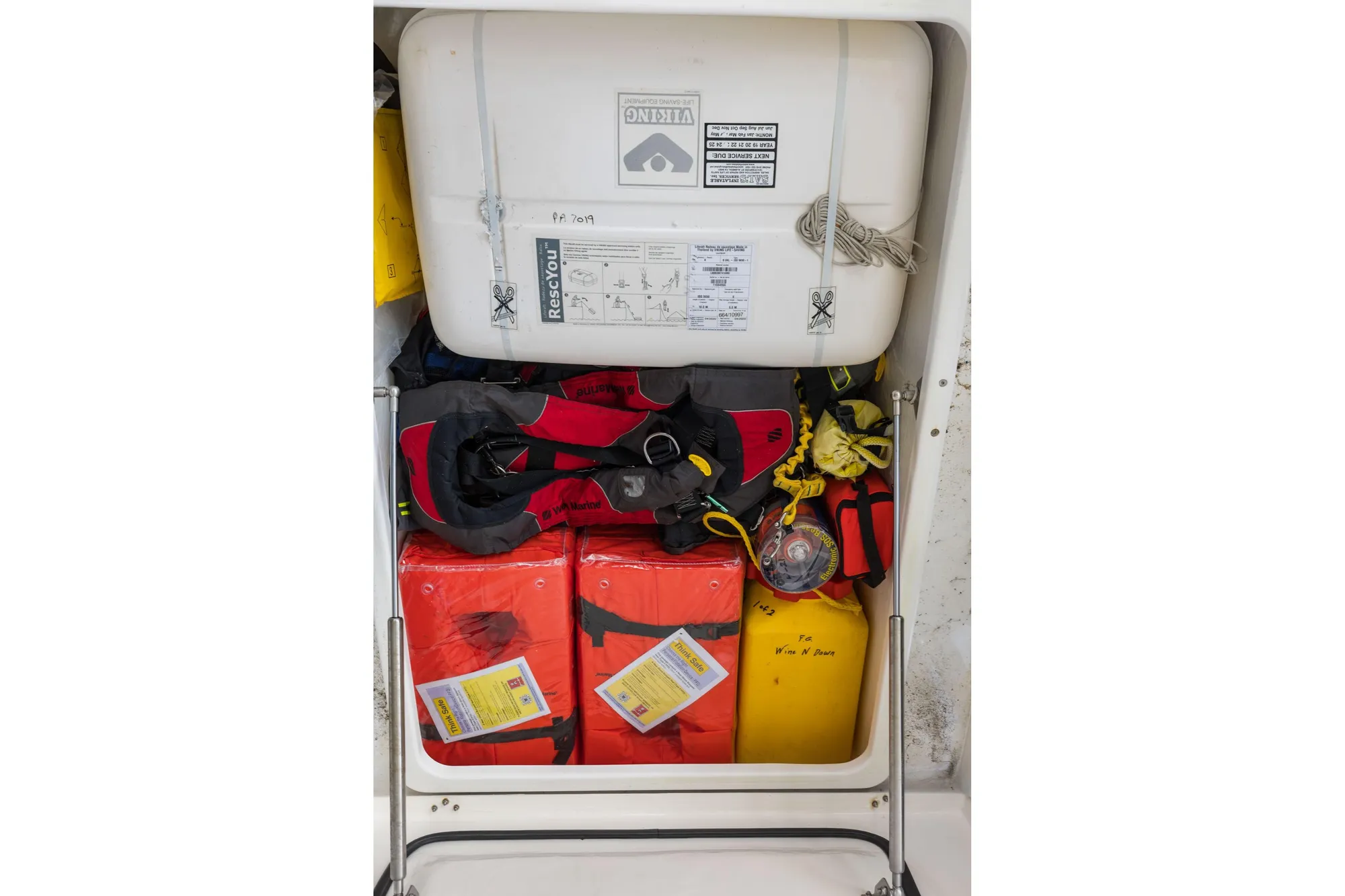 Safety equipment storage on a 2015 Leopard 58 yacht, featuring life jackets and rescue gear.