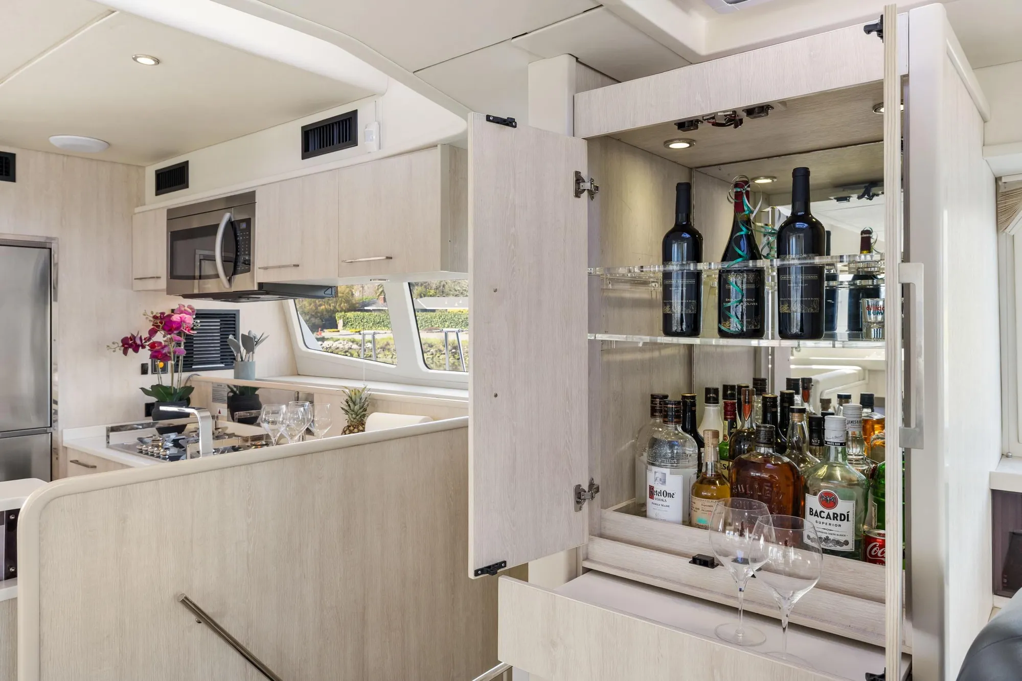 Luxurious Leopard 58 yacht interior with modern kitchen and well-stocked bar, 2015 model.